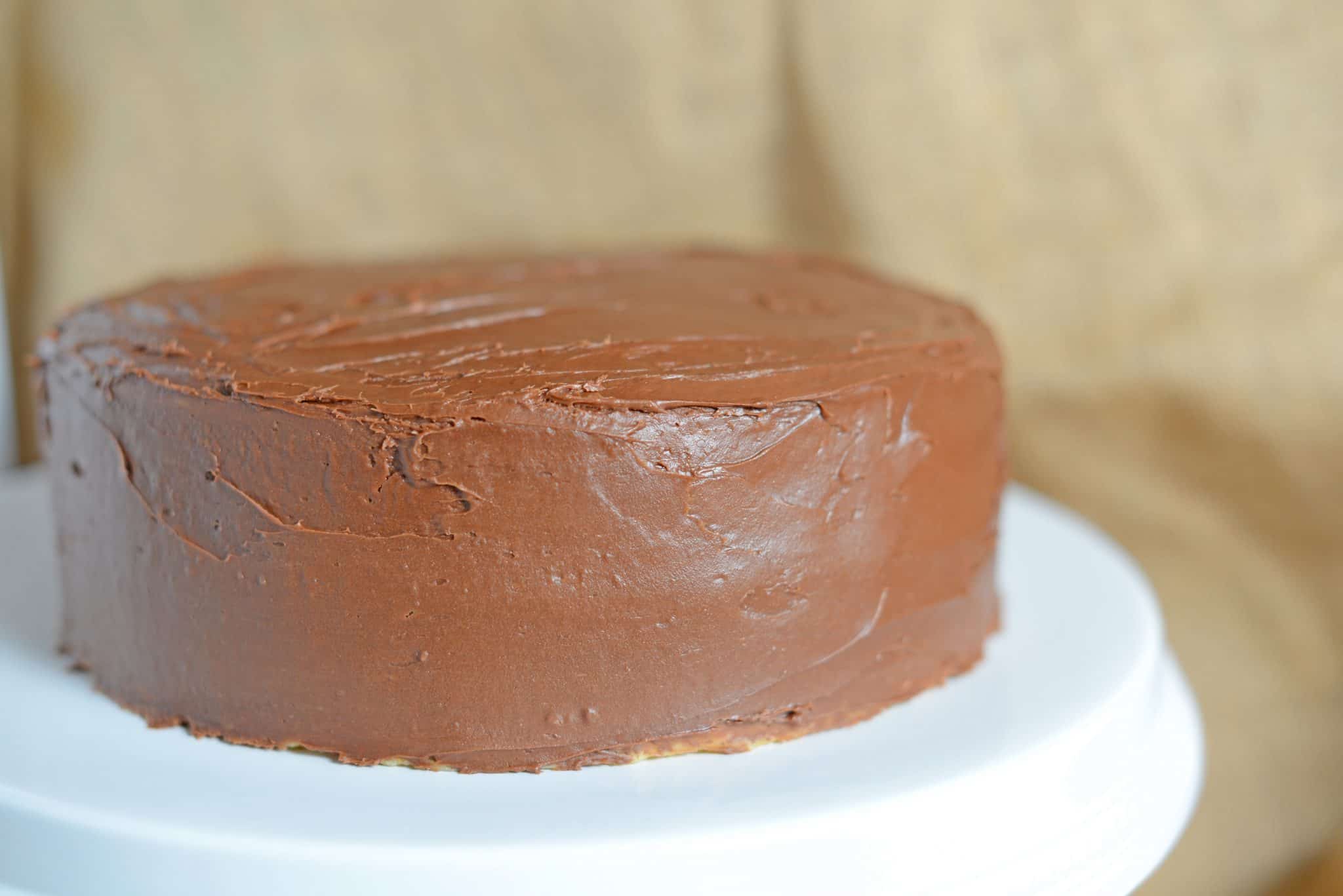 Brown Butter Cake is an easy cake made from scratch using delicious brown butter, chocolate mousse filling and chocolate buttercream frosting. #brownbuttercake #layercakerecipes www.savoryexperiments.com