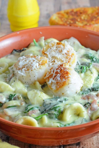 Scallion Pesto Scallop Pasta is a restaurant quality dish, creamy pasta sauce with garlic, Swiss chard, prosciutto and seared scallops. #pastarecipes #scalloprecipes www.savoryexperiments.com