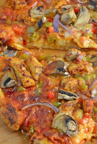 Caribbean Jerk Chicken Pizza is an easy homemade pizza recipe using spicy chicken, fresh vegetables and a touch of honey. #homemadepizza #jerkchicken #jerkchickenpizza www.savoryexperiments.com