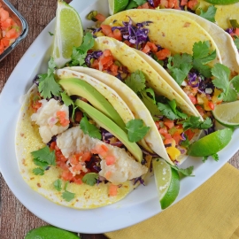 Easy fish taco recipe full of flavor with pico de gallo, shredded cabbage, avocado, queso fresco and a special homemade hot sauce. #fishtacorecipe #bestfishtacos www.savoryexperiments.com