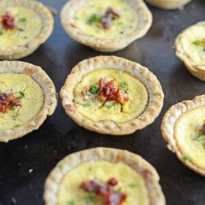 Make easy and delicious individual goat cheese quiche! Eggs whipped with goat cheese, sun dried tomatoes, pine nuts and Parmesan cheese, these are perfect for brunch, an appetizer or entree.