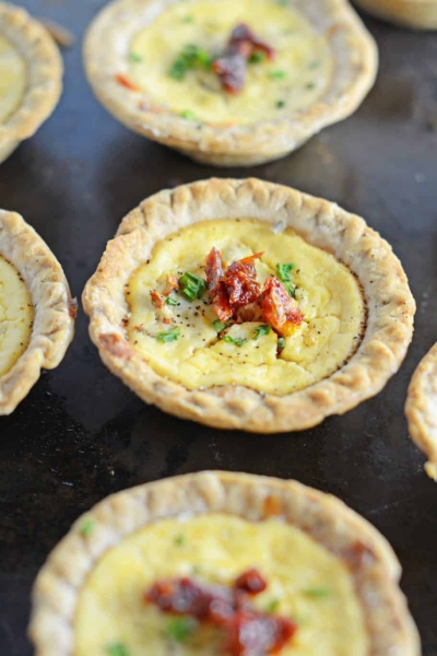 Make easy and delicious individual goat cheese quiche! Eggs whipped with goat cheese, sun dried tomatoes, pine nuts and Parmesan cheese, these are perfect for brunch, an appetizer or entree.