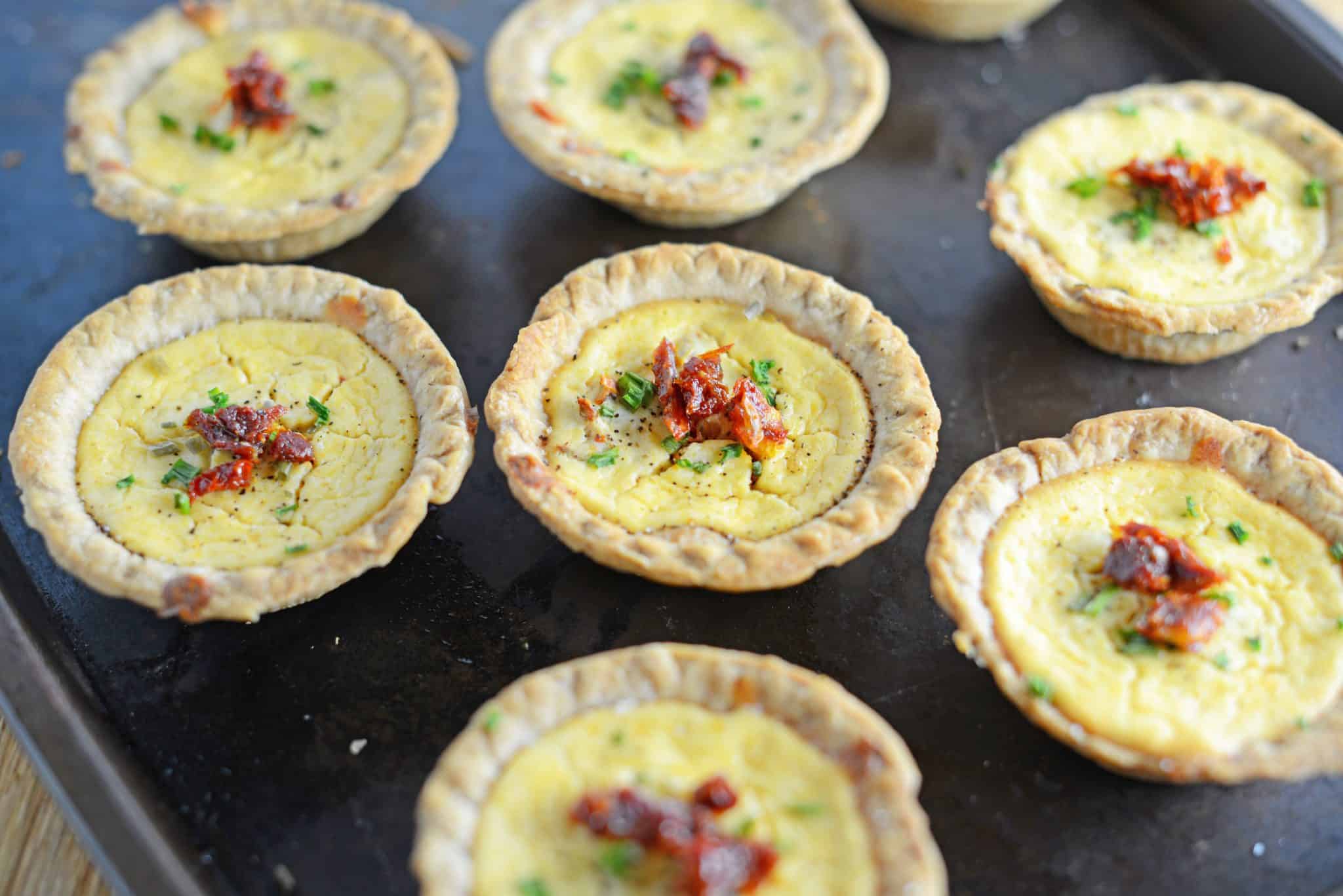 Make easy and delicious individual goat cheese quiche! Eggs whipped with goat cheese, sun dried tomatoes, pine nuts and Parmesan cheese, these are perfect for brunch, an appetizer or entree.