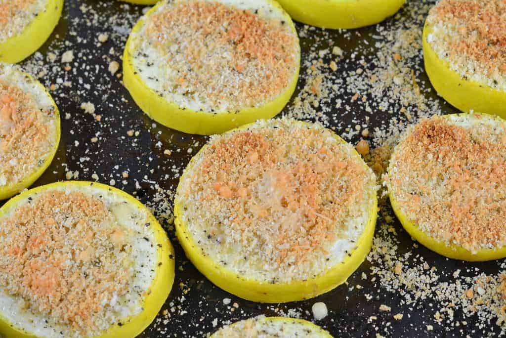 This Parmesan Crusted Yellow Squash recipe is baked and topped with parmesan cheese and bread crumbs. It'll become your new favorite summer squash recipe side dish! #summersquashrecipe #yellowsquashrecipes www.savoryexperiments.com