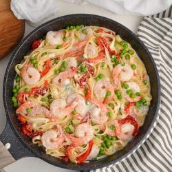 overhead of shrimp alfredo in a large skillet