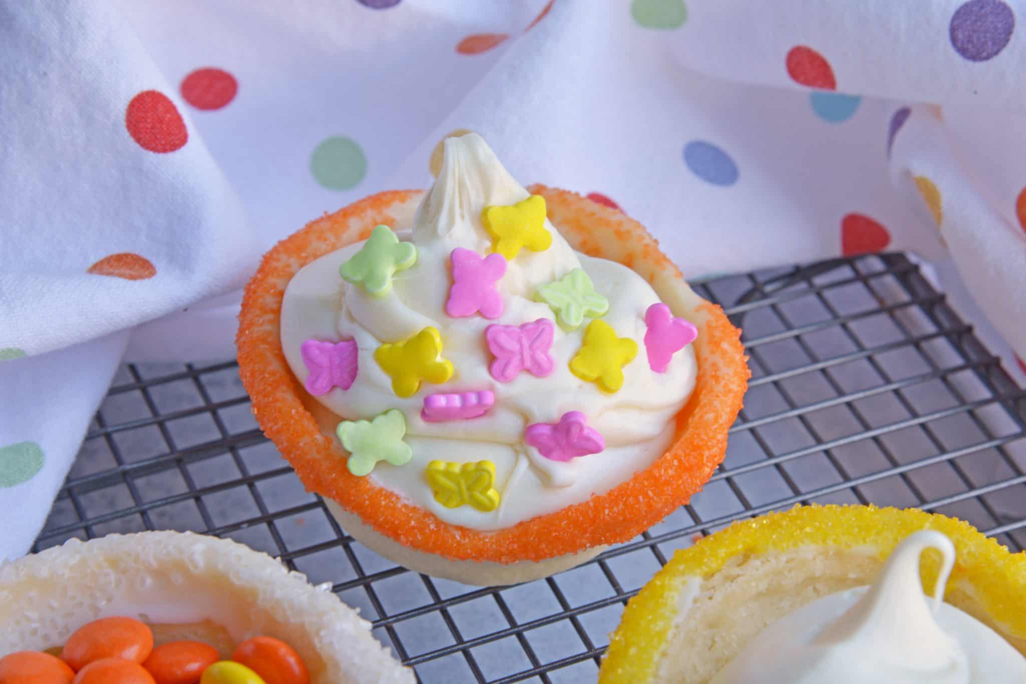 This Sugar Cookie Cups recipe puts a spin on your typical ice cream cone. Why choose between cookies or ice cream when you can have both! #sugarcookiecups #howtomakesugarcookiecups www.savoryexperiments.com