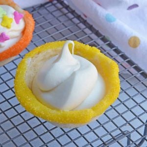 This Sugar Cookie Cups recipe puts a spin on your typical ice cream cone. Why choose between cookies or ice cream when you can have both! #sugarcookiecups #howtomakesugarcookiecups www.savoryexperiments.com