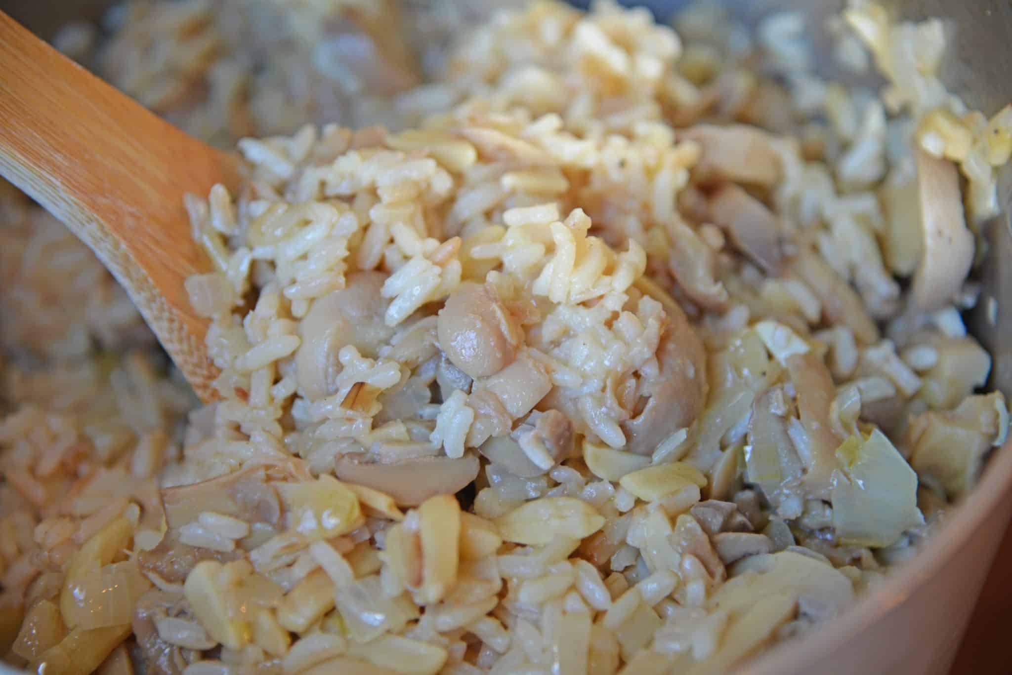 Almond Rice Pilaf is an easy side dish made with crunchy almonds, mushrooms and savory chicken broth and lemon juice to give it loads of flavor! An easy rice recipe the whole family will love. #ricepilafrecipe #easysidedish www.savoryexperiments.com 