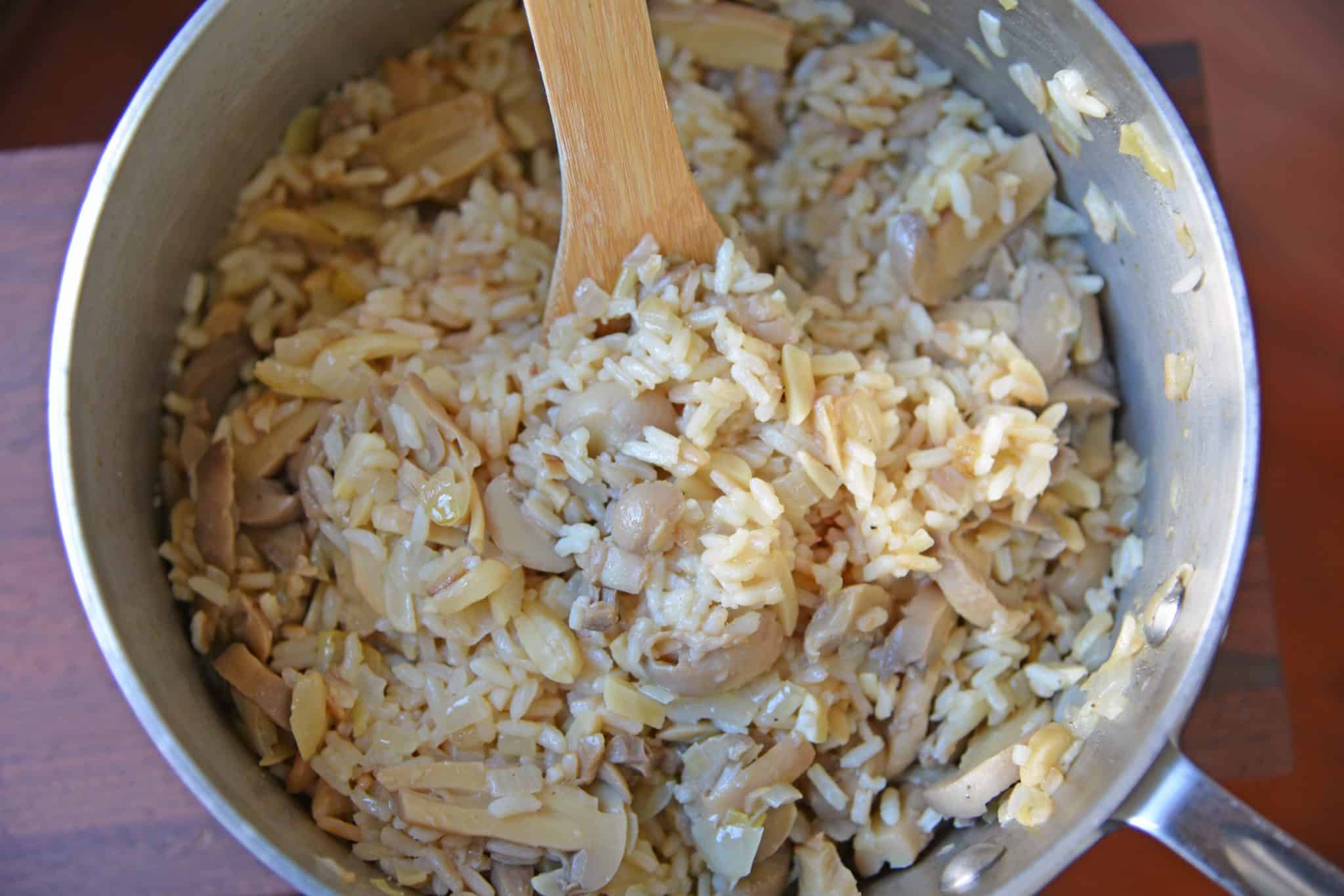 Almond Rice Pilaf is an easy side dish made with crunchy almonds, mushrooms and savory chicken broth and lemon juice to give it loads of flavor! An easy rice recipe the whole family will love. #ricepilafrecipe #easysidedish www.savoryexperiments.com 