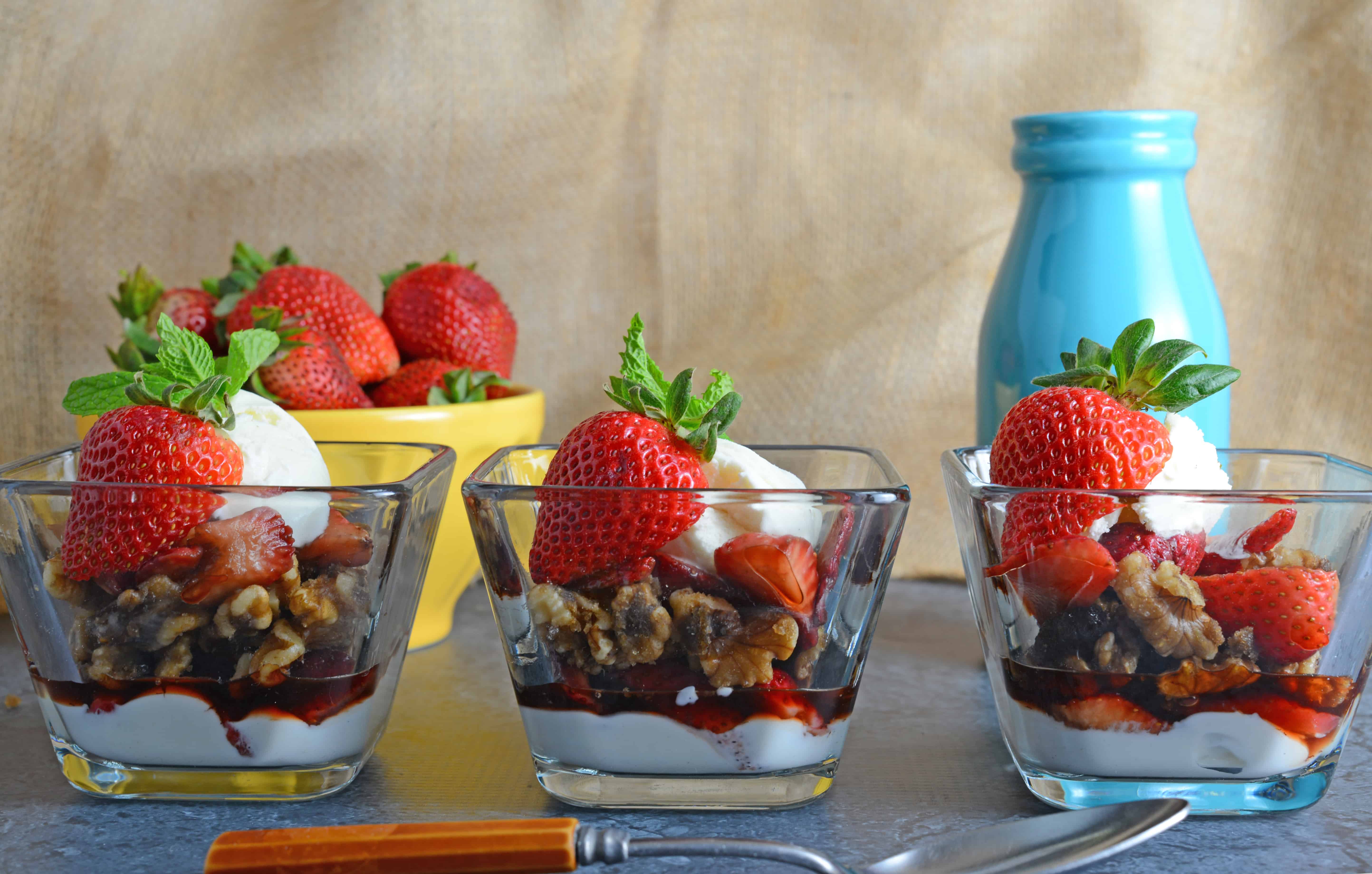 Balsamic Strawberry Parfait- Easy dessert recipe with layers of ice cream, yogurt-whipped cream mix, macerated strawberries and candied walnuts. Perfect for feeding a crowd or dinner parties! www.savoryexperiments.com