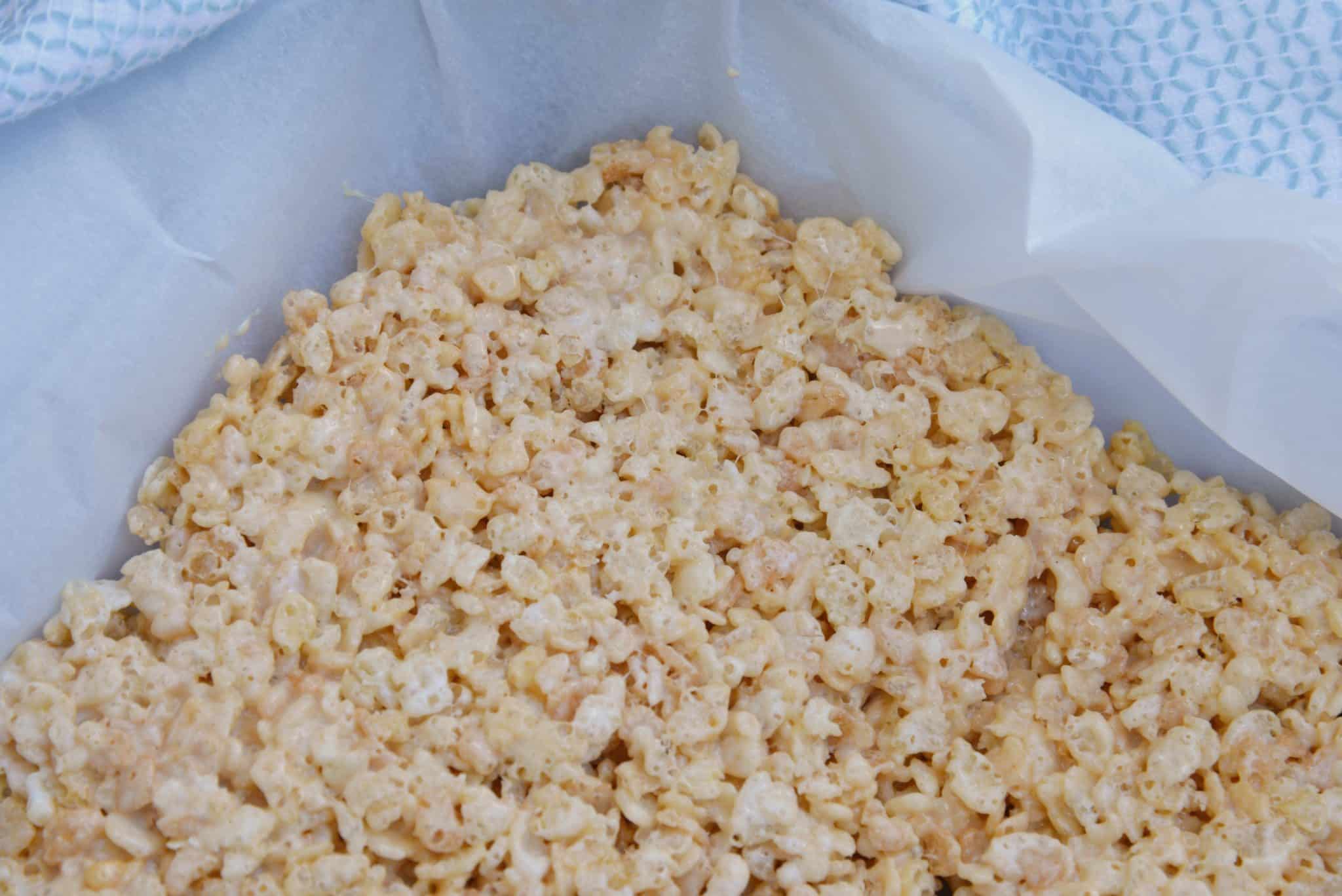 Caramel Rice Krispie Treats are a new twist on an old favorite! These homemade Rice Krispie Treats are so good and miles better then the store bought ones! #homemadericekrispietreats #carameldesserts www.savoryexperiments.com