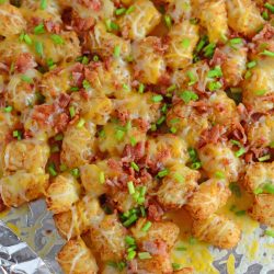 Cheesy loaded tater tots on a foil lined pan