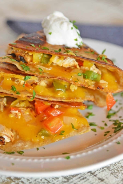 pile of chicken quesadillas with sour cream