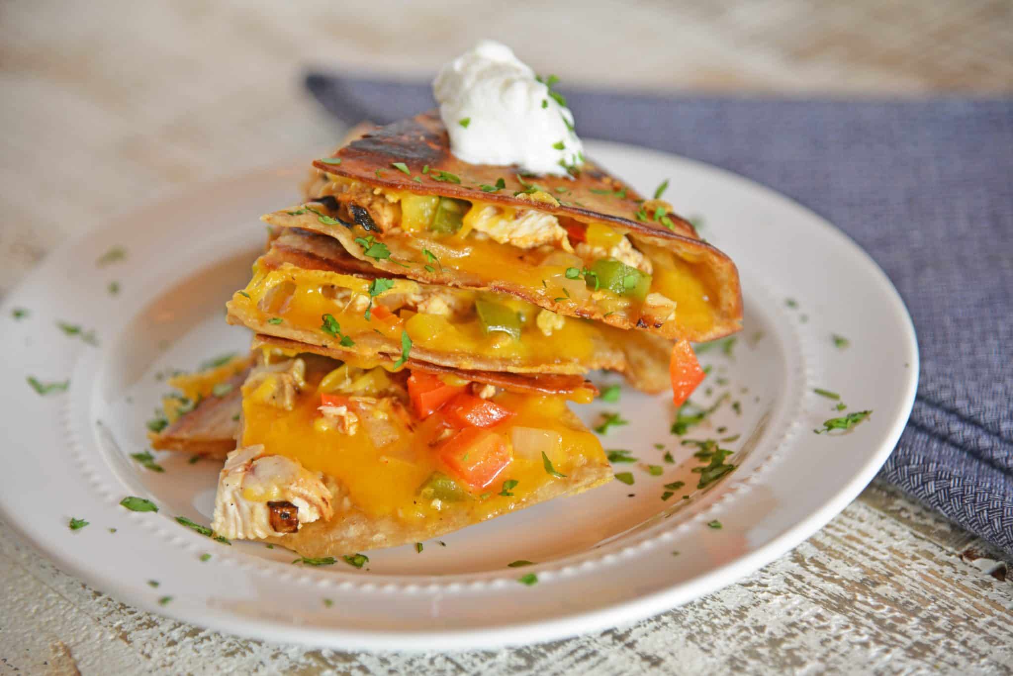 pile of chicken quesadillas with sour cream 