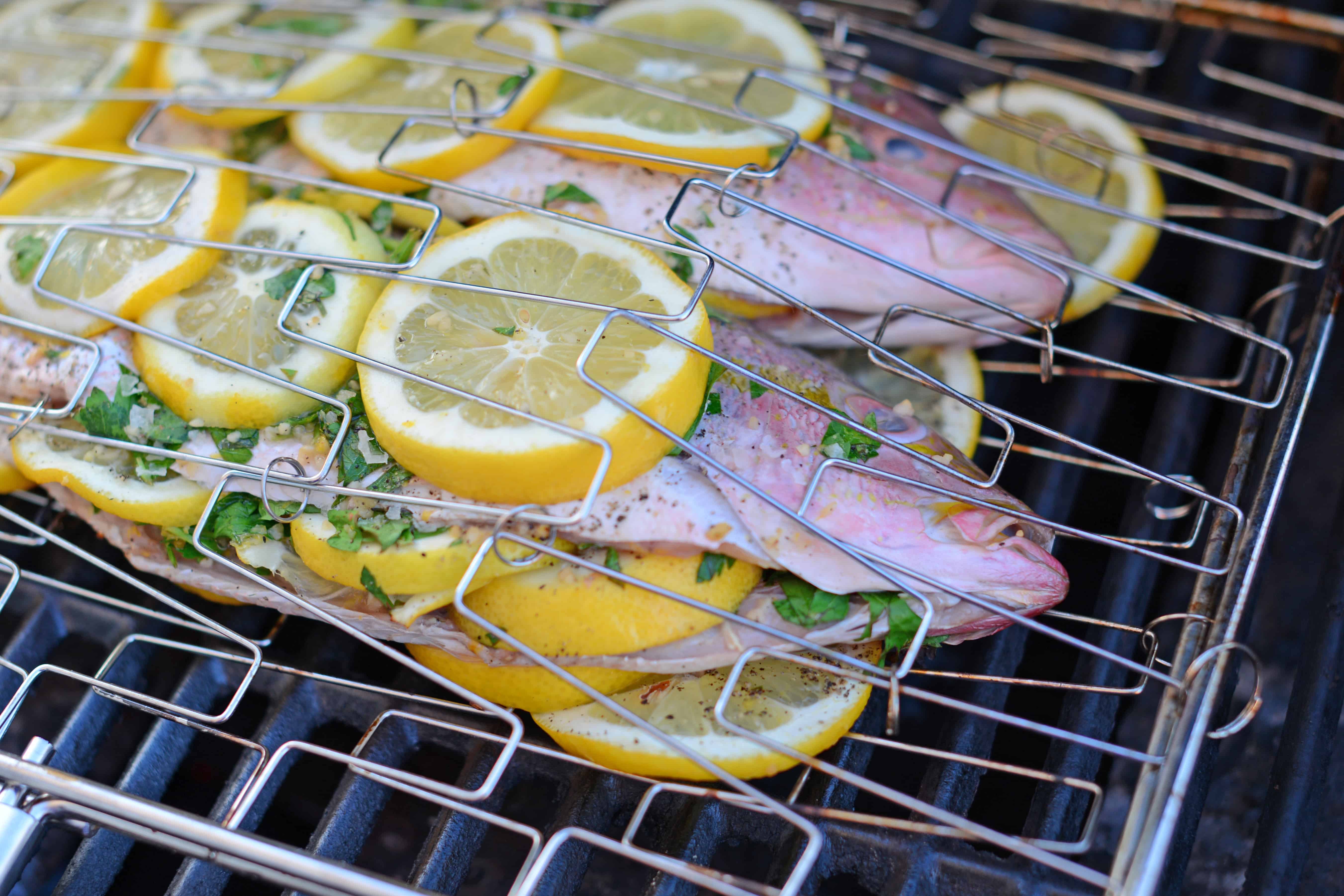 Grilled Red Snapper- how to prepare and grill whole fish with fresh herbs and lemon, Mediterranean style fish at home! You won’t believe how easy it is to make your own whole fish! www.savoryexperiments.com