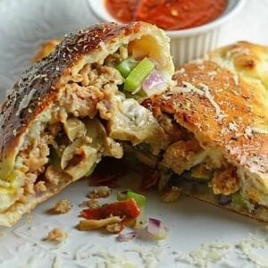 This Easy Calzones Recipe is made with just a handful of ingredients! This homemade calzones recipe is perfect for a “make your own calzone bar” for any party! #calzonerecipe #howtomakeacalzone #homemadecalzonerecipe www.savoryexperiments.com