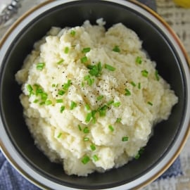 Mashed Cauliflower is a healthier alternative to mashed potatoes, with fewer carbs! This Mashed Cauliflower recipe is perfectly smooth and creamy! #mashedcauliflower #cauliflowermashedpotatoes www.savoryexperiments.com