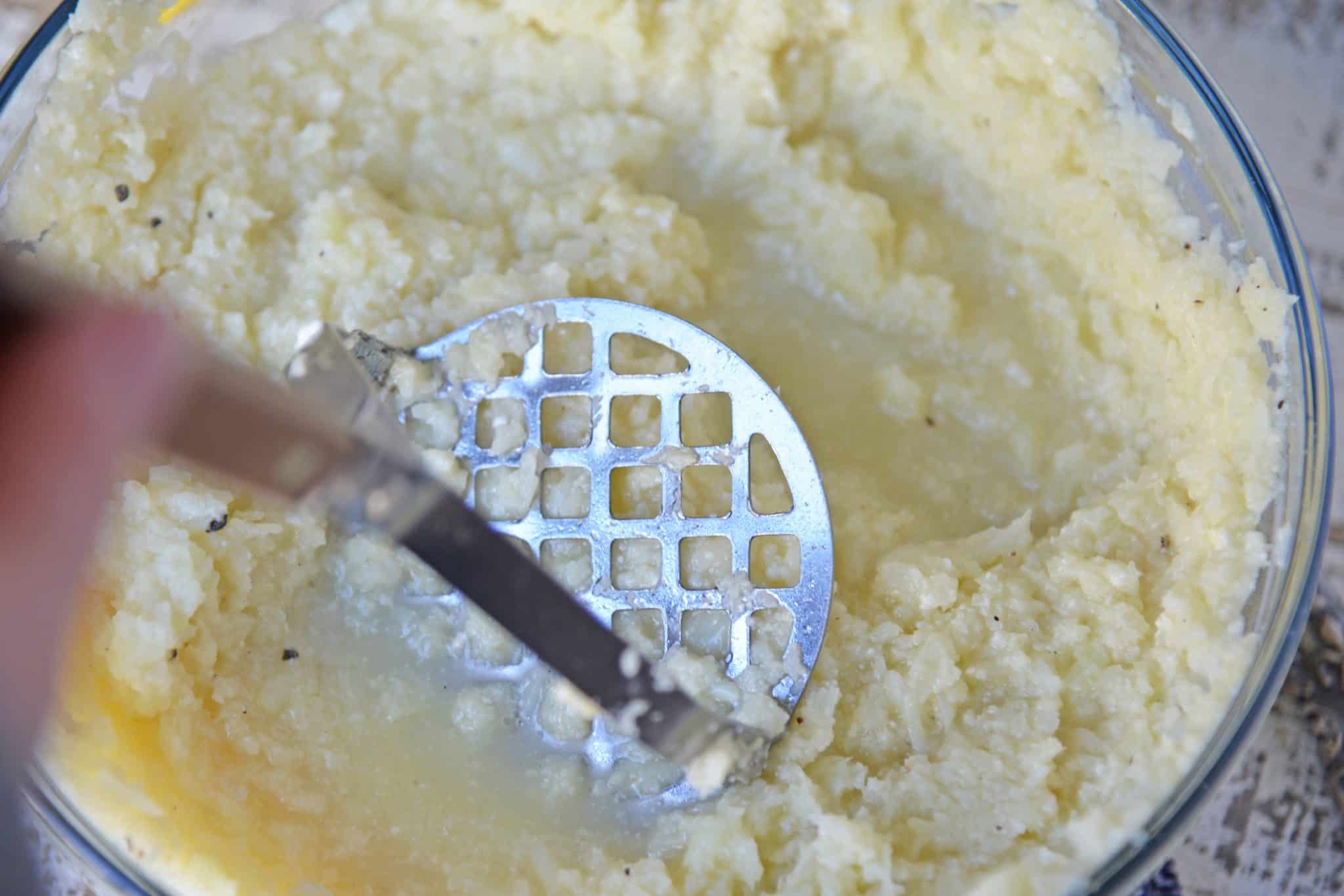 Mashed Cauliflower is a healthier alternative to mashed potatoes, with fewer carbs! This Mashed Cauliflower recipe is perfectly smooth and creamy! #mashedcauliflower #cauliflowermashedpotatoes www.savoryexperiments.com