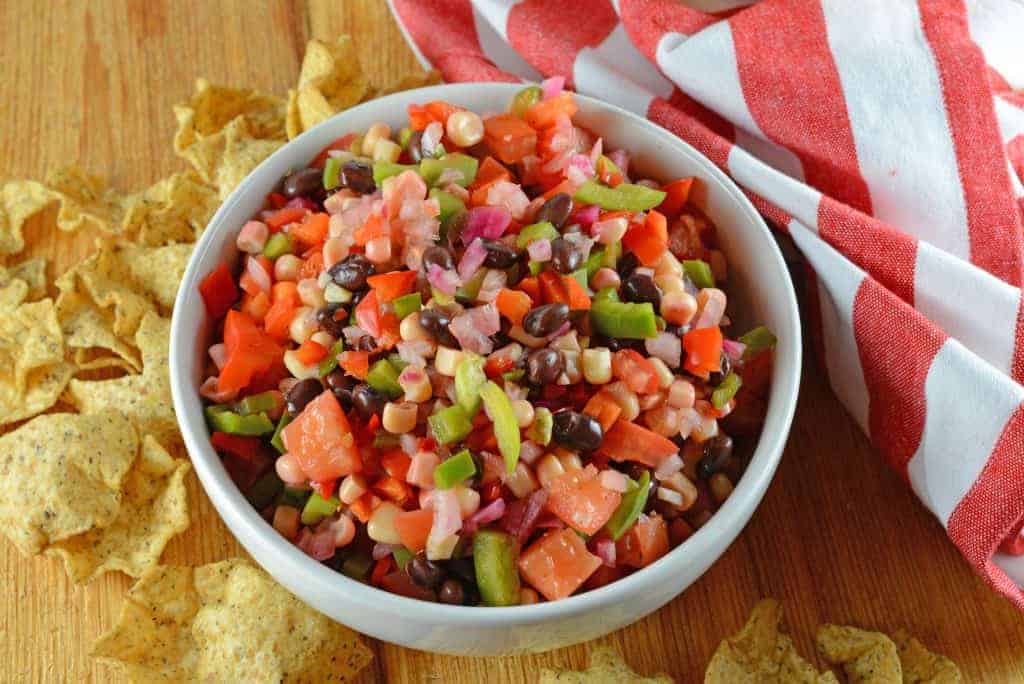 Cowboy Caviar Dip is my most popular recipe! This Texas caviar is made with fresh vegetables, black beans and a simple marinade! #cowboycaviar #texascaviar #bbqappetizer www.savoryexperiments.com