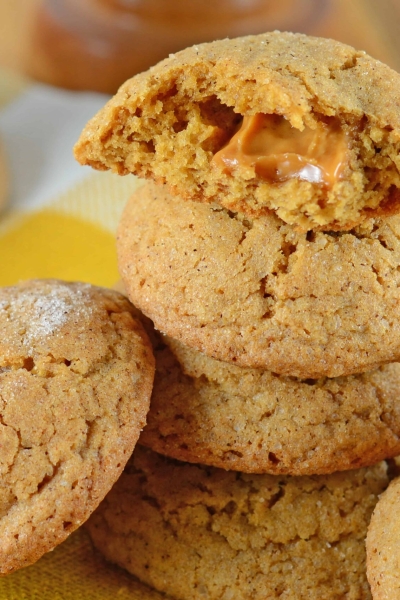 Caramel Apple Cookies are an easy, mess free way to enjoy a caramel apple! This fall cookie recipe is apple spiced cookie dough stuffed with gooey caramel! #applecookies #caramelapple #fallcookierecipe www.savoryexperiments.com
