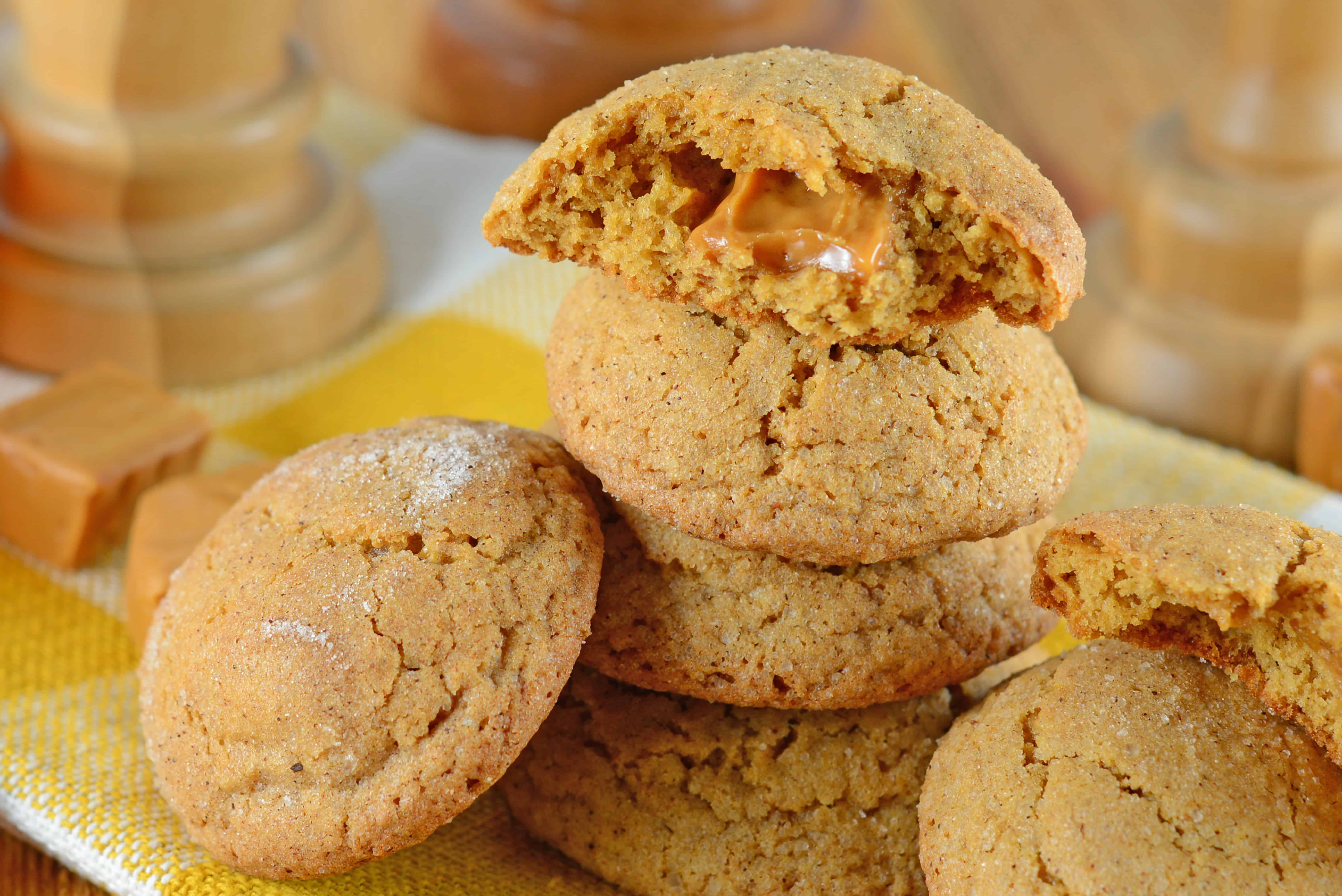 Caramel Apple Cookies are an easy, mess free way to enjoy a caramel apple! This fall cookie recipe is apple spiced cookie dough stuffed with gooey caramel! #applecookies #caramelapple #fallcookierecipe www.savoryexperiments.com