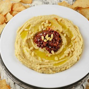 Spicy Hummus with Chipotle Peppers is a spicy homemade hummus recipe. This is the best hummus recipes to make because it is so easy and it stores great! #besthummusrecipe #homemadehummus #howtomakehummus www.savoryexperiments.com