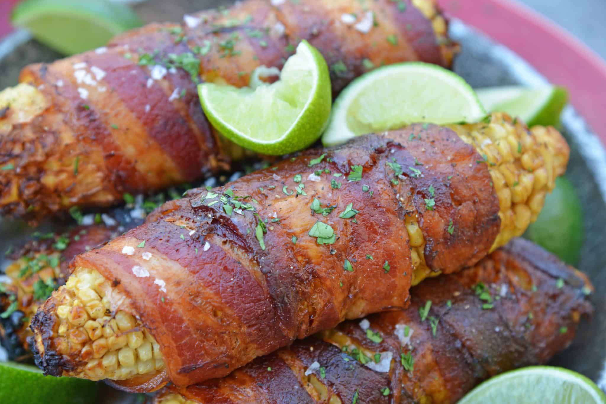 Cilantro Lime Bacon Wrapped Corn is a zesty grilled corn side dish that is perfect for any summer BBQ or Mexican fiesta! A sweet & zesty flavor combination! #grilledcorn #baconwrappedcorn #mexicancorn www.savoryexperiments.com