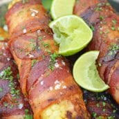 Cilantro Lime Bacon Wrapped Corn is a zesty grilled corn side dish that is perfect for any summer BBQ or Mexican fiesta! A sweet & zesty flavor combination! #grilledcorn #baconwrappedcorn #mexicancorn www.savoryexperiments.com