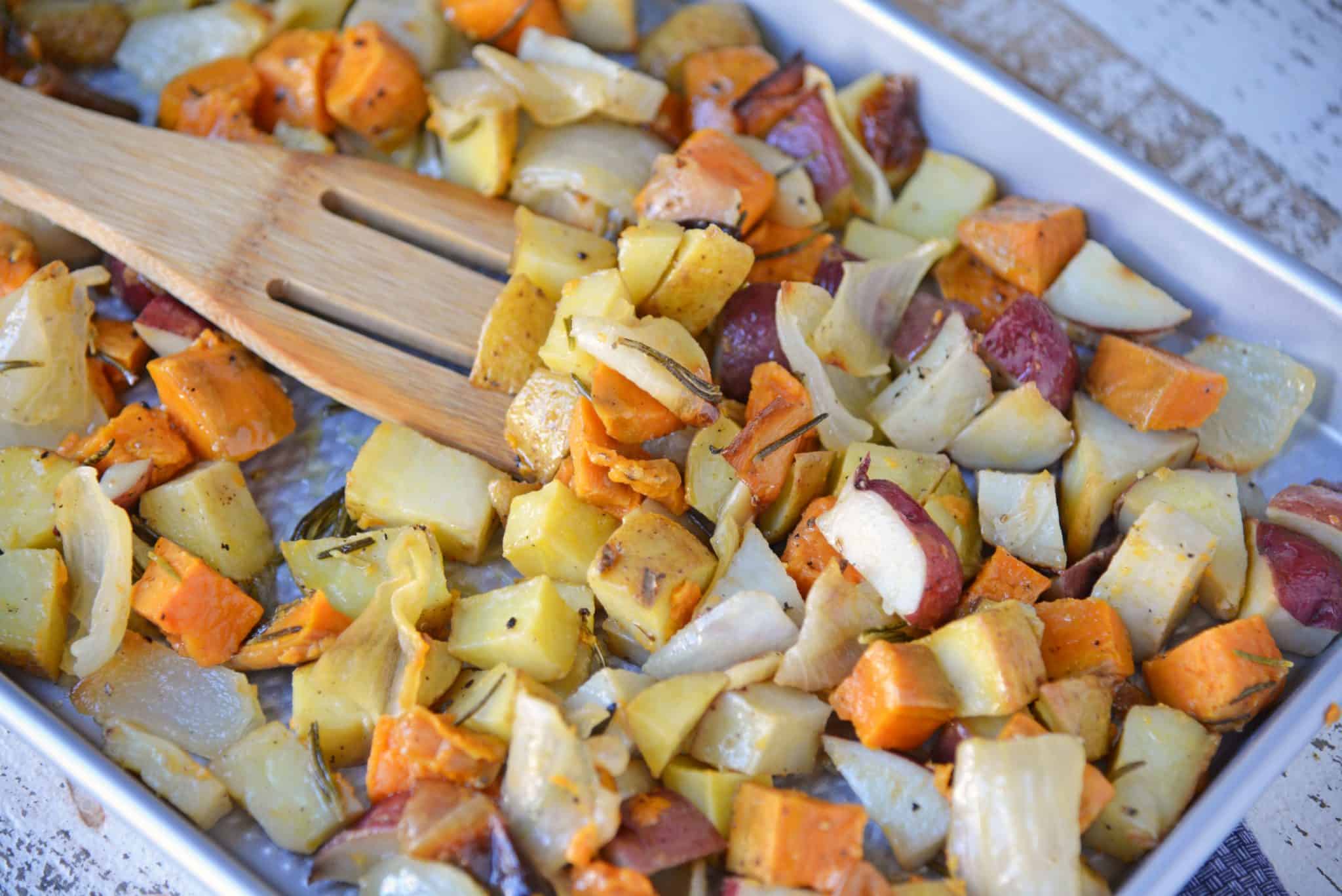 Garlic Roasted Potatoes with Rosemary are a mix of sweet and Yukon gold potatoes baked to a golden brown with olive oil, fresh rosemary, garlic and sweet onion! #ovenroastedpotatoes #garlicroastedpotatoes #potatorecipes www.savoryexperiments.com