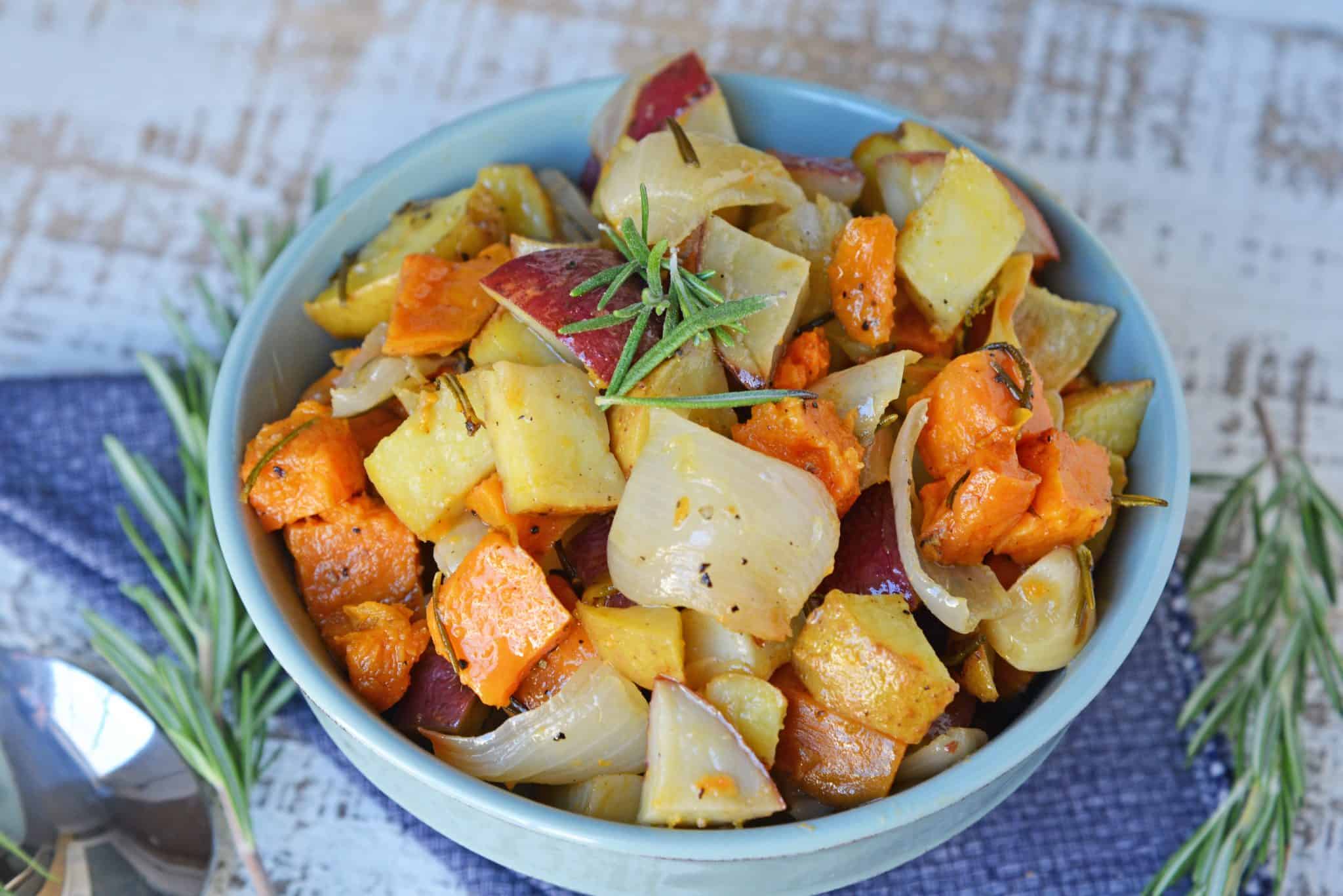 Garlic Roasted Potatoes with Rosemary are a mix of sweet and Yukon gold potatoes baked to a golden brown with olive oil, fresh rosemary, garlic and sweet onion! #ovenroastedpotatoes #garlicroastedpotatoes #potatorecipes www.savoryexperiments.com