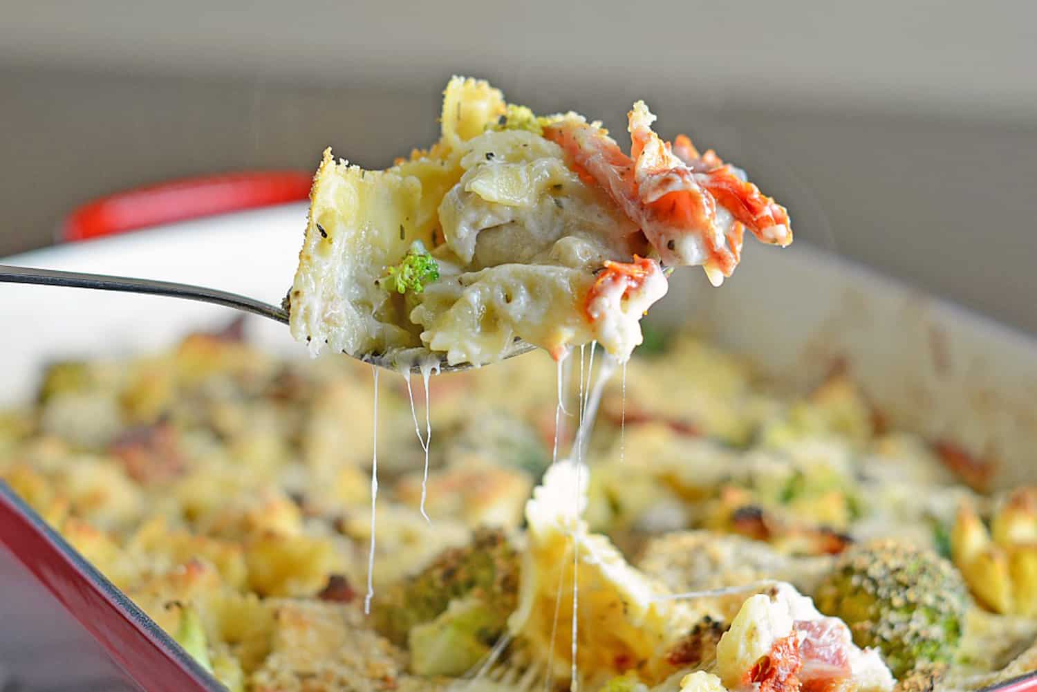 Cheesy Chicken Casserole is an easy casserole recipe perfect for feeding a large family on a budget. Chicken, cheese, pasta and vegetables- delicious! #easycasserolerecipes #bestchickenrecipes www.savoryexperiments.com 