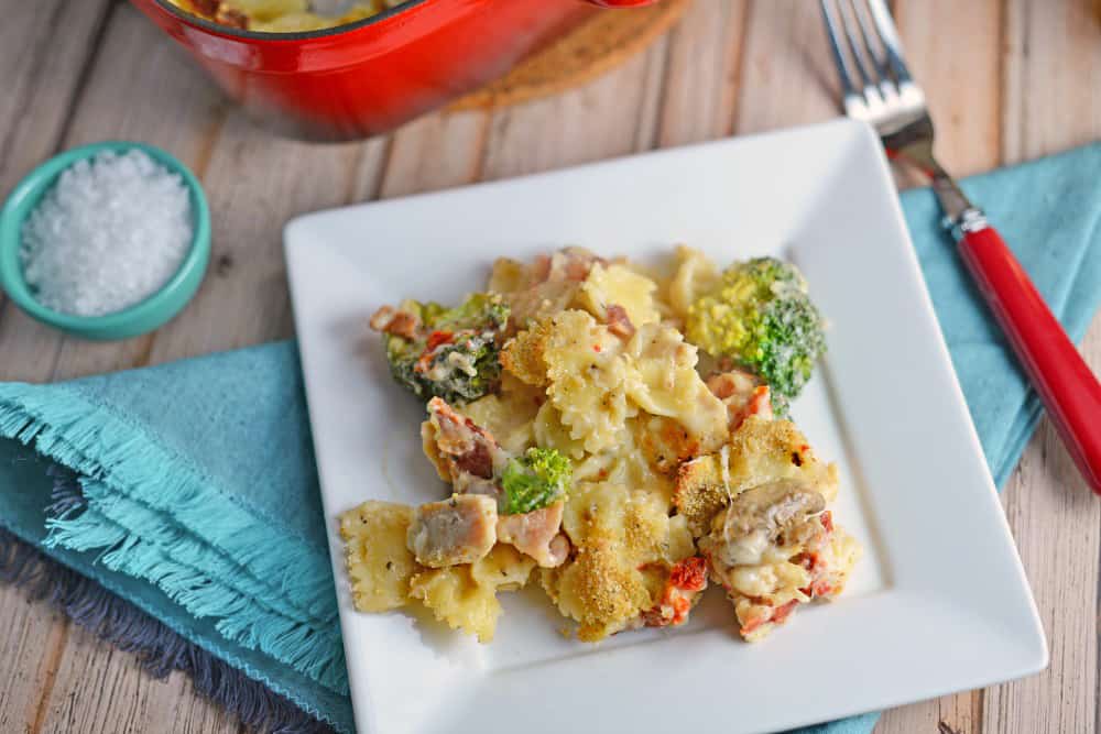 Cheesy Chicken Casserole is an easy casserole recipe perfect for feeding a large family on a budget. Chicken, cheese, pasta and vegetables- delicious! #easycasserolerecipes #bestchickenrecipes www.savoryexperiments.com 