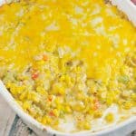 Mexican Corn Dip is a decadent and colorful appetizer recipe! A mix of corn, spices, bell peppers, jalapenos, and onion, will bring a fiesta to your table! #corndip #hotcorndip www.savoryexperiments.com