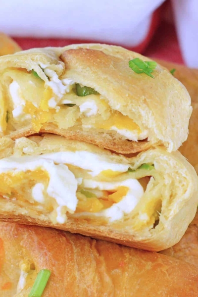 close up of jalapeno popper crescent roll cut in half