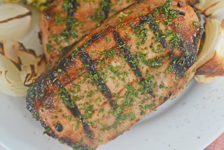 onion grilled pork chops on a plate