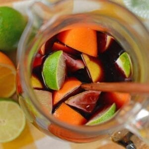 This Red Sangria recipe shows you how to make sangria the simplest way possible! It's made with sweet red wine, fresh fruit, sprite, lemonade, and fruit punch! #howtomakesangria #bestsangriarecipe #easysangriarecipe www.savoryexperiments.com
