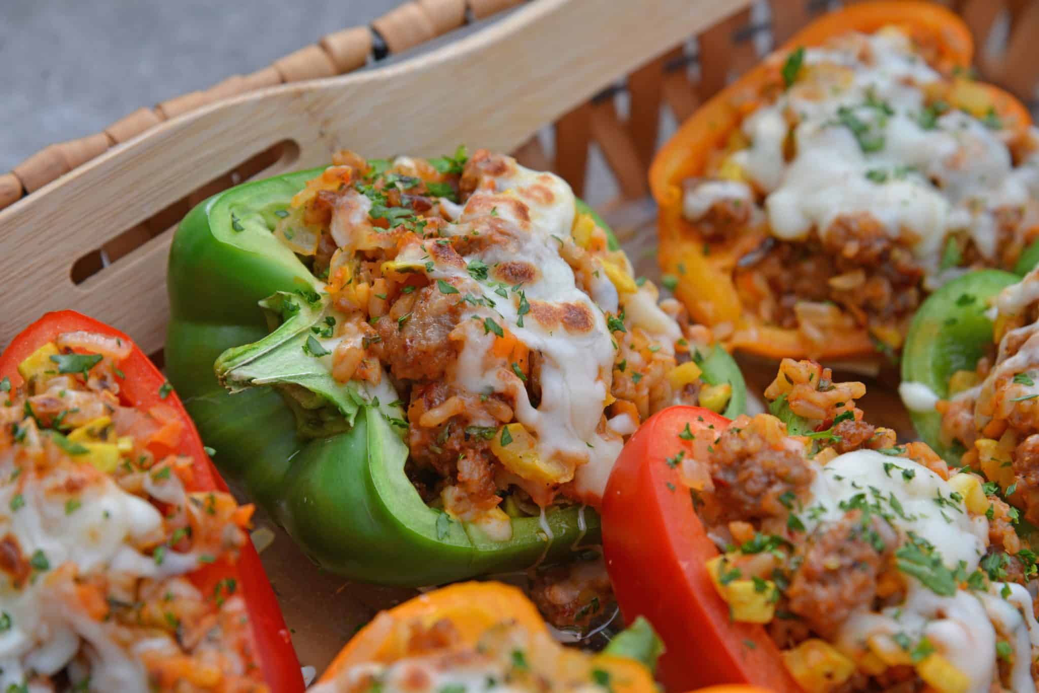 Sausage Stuffed Bell Peppers are a classic Italian dish using stuffed peppers with rice, sausage and lots of colorful vegetables. This make ahead dinner recipe will be a family favorite. #makeaheaddinner #stuffedbellepeppers www.savoryexperiments.com