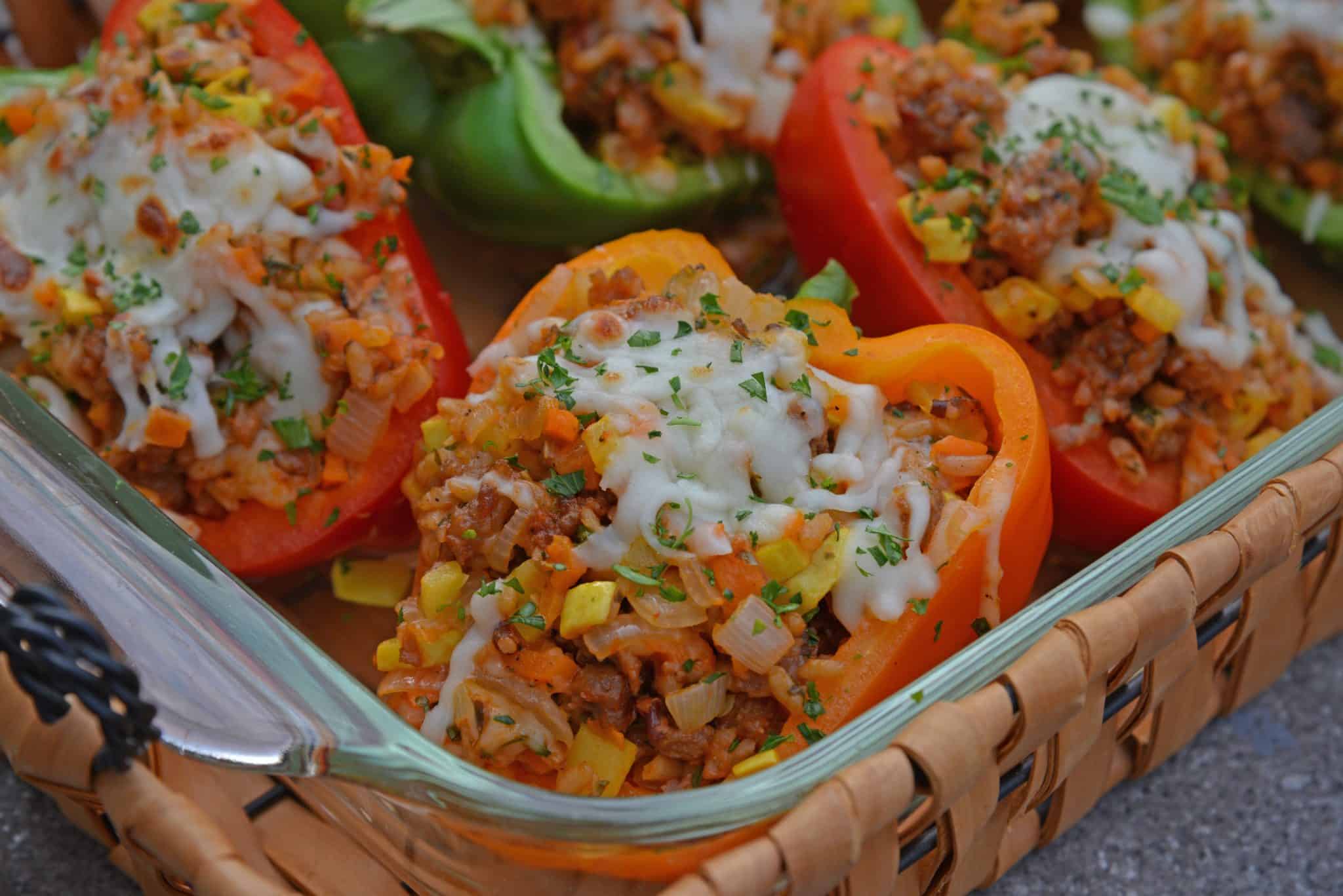 Sausage Stuffed Bell Peppers are a classic Italian dish using stuffed peppers with rice, sausage and lots of colorful vegetables. This make ahead dinner recipe will be a family favorite. #makeaheaddinner #stuffedbellepeppers www.savoryexperiments.com