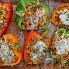 Sausage Stuffed Bell Peppers are a classic Italian dish using stuffed peppers with rice, sausage and lots of colorful vegetables. This make ahead dinner recipe will be a family favorite. #makeaheaddinner #stuffedbellepeppers www.savoryexperiments.com