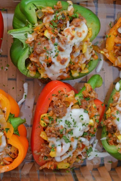 Sausage Stuffed Bell Peppers are a classic Italian dish using stuffed peppers with rice, sausage and lots of colorful vegetables. This make ahead dinner recipe will be a family favorite. #makeaheaddinner #stuffedbellepeppers www.savoryexperiments.com