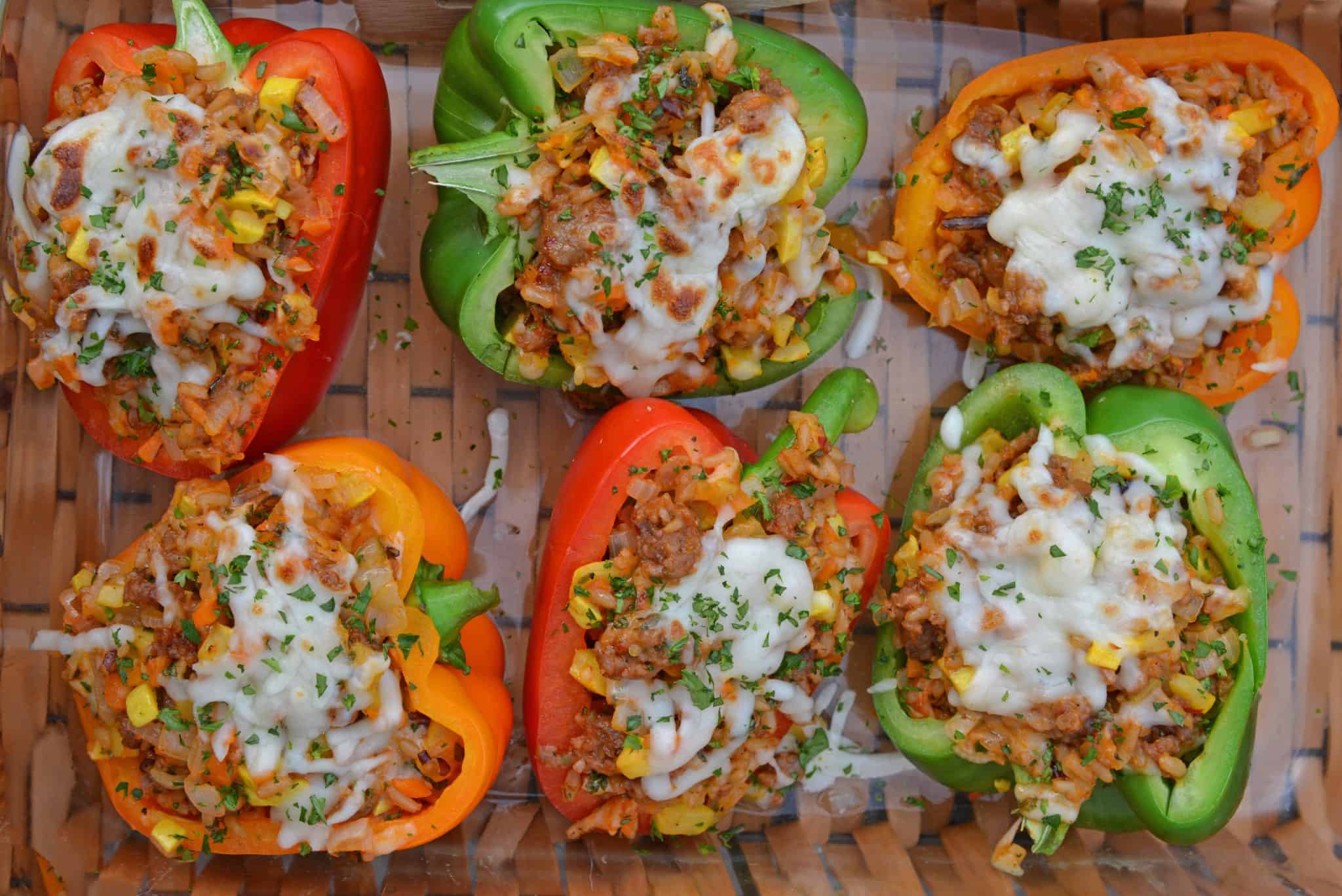 Sausage Stuffed Bell Peppers are a classic Italian dish using stuffed peppers with rice, sausage and lots of colorful vegetables. This make ahead dinner recipe will be a family favorite. #makeaheaddinner #stuffedbellepeppers www.savoryexperiments.com