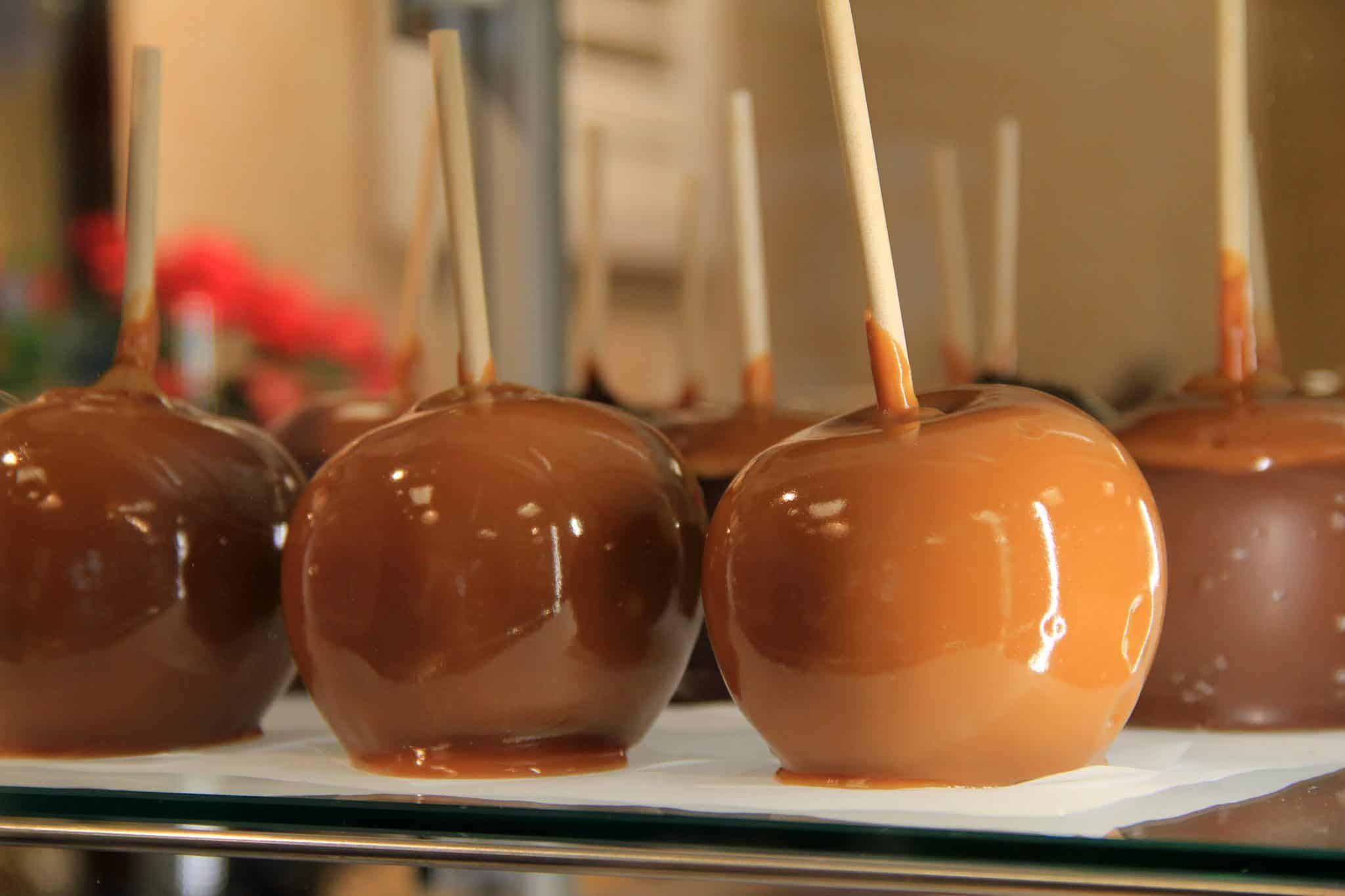 Classic caramel apples recipe with 20+ ideas to roll them in. Perfect for a fall dessert idea or a Halloween treat! #caramelapples www.savoryexperiments.com