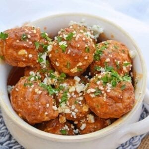 Buffalo Chicken Meatballs are a quick and easy appetizer that will spice up any party! Simmered in spicy wing sauce and blue cheese, these will be a winner! #buffalochicken #partymeatballs #buffalochickenmeatballs www.savoryexperiments.com