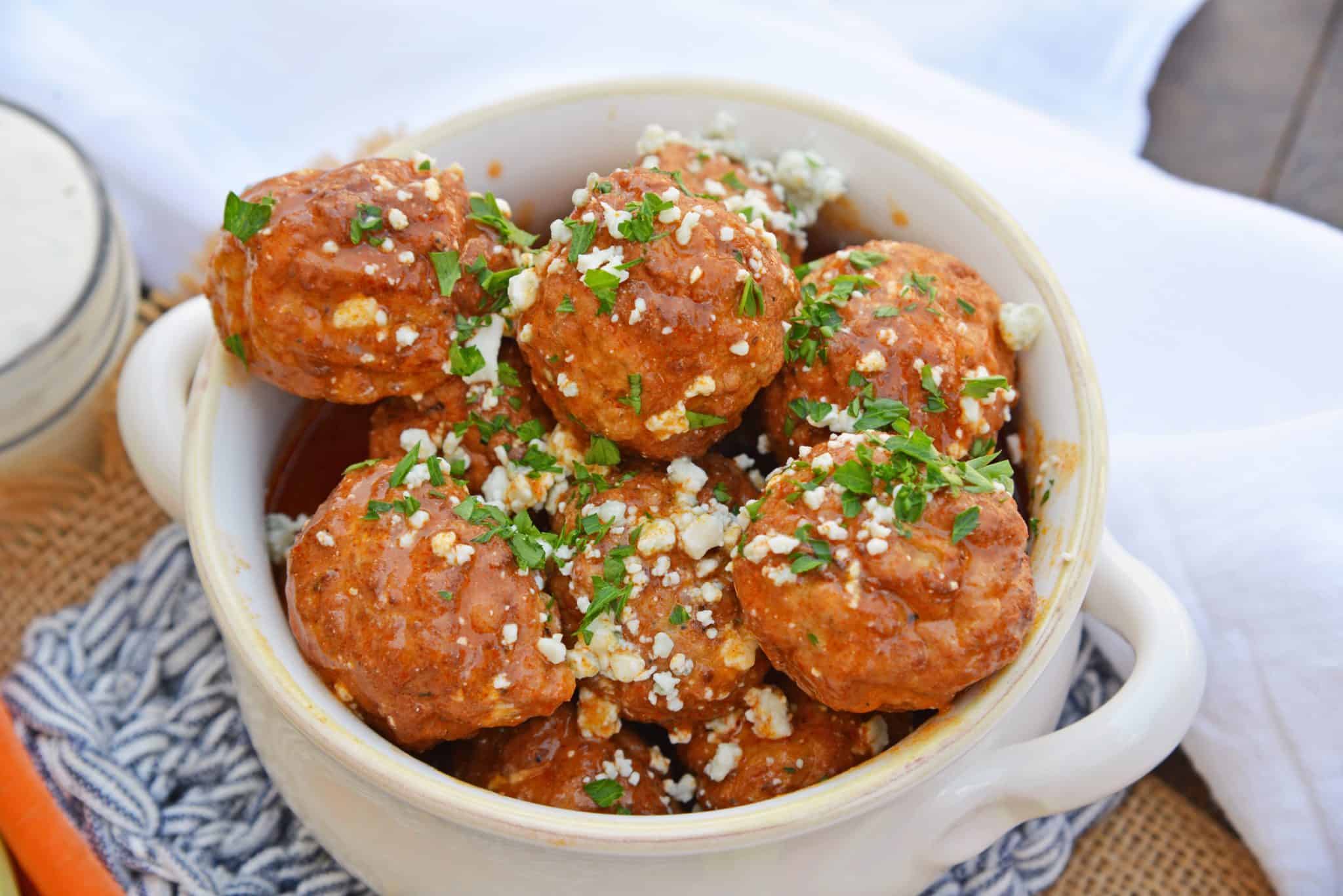 Buffalo Chicken Meatballs are a quick and easy appetizer that will spice up any party! Simmered in spicy wing sauce and blue cheese, these will be a winner! #buffalochicken #partymeatballs #buffalochickenmeatballs www.savoryexperiments.com