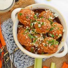 Buffalo Chicken Meatballs are a quick and easy appetizer that will spice up any party! Simmered in spicy wing sauce and blue cheese, these will be a winner! #buffalochicken #partymeatballs #buffalochickenmeatballs www.savoryexperiments.com