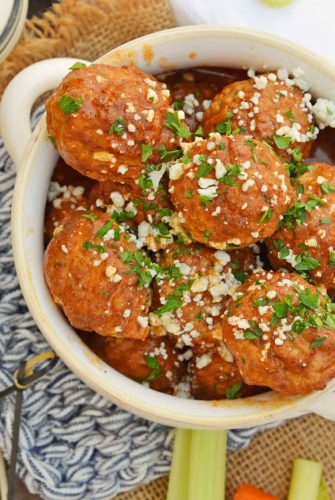 Buffalo Chicken Meatballs are a quick and easy appetizer that will spice up any party! Simmered in spicy wing sauce and blue cheese, these will be a winner! #buffalochicken #partymeatballs #buffalochickenmeatballs www.savoryexperiments.com
