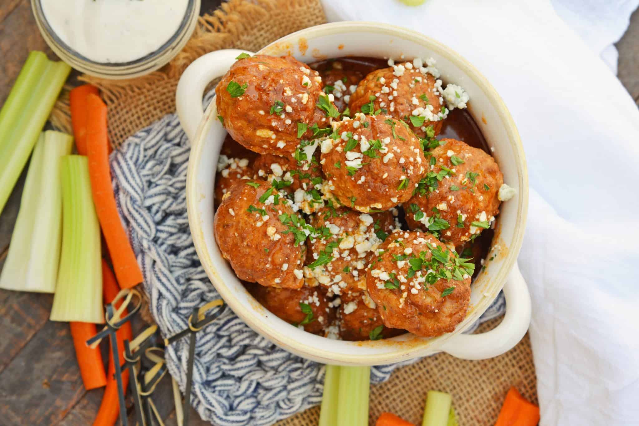 Buffalo Chicken Meatballs are a quick and easy appetizer that will spice up any party! Simmered in spicy wing sauce and blue cheese, these will be a winner! #buffalochicken #partymeatballs #buffalochickenmeatballs www.savoryexperiments.com