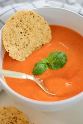 spoon in bowl of tomato soup