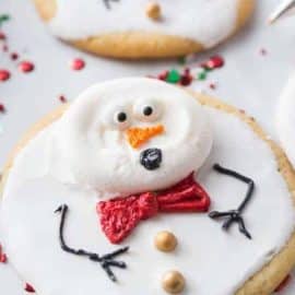 Super easy and fun to decorate, Melted Snowman Cookies are great for a children's project on a cold winter day. The cutest Christmas cookies ever! #meltedsnowmancookies #meltingsnowmen #easychristmascookies www.savoryexperiments.com