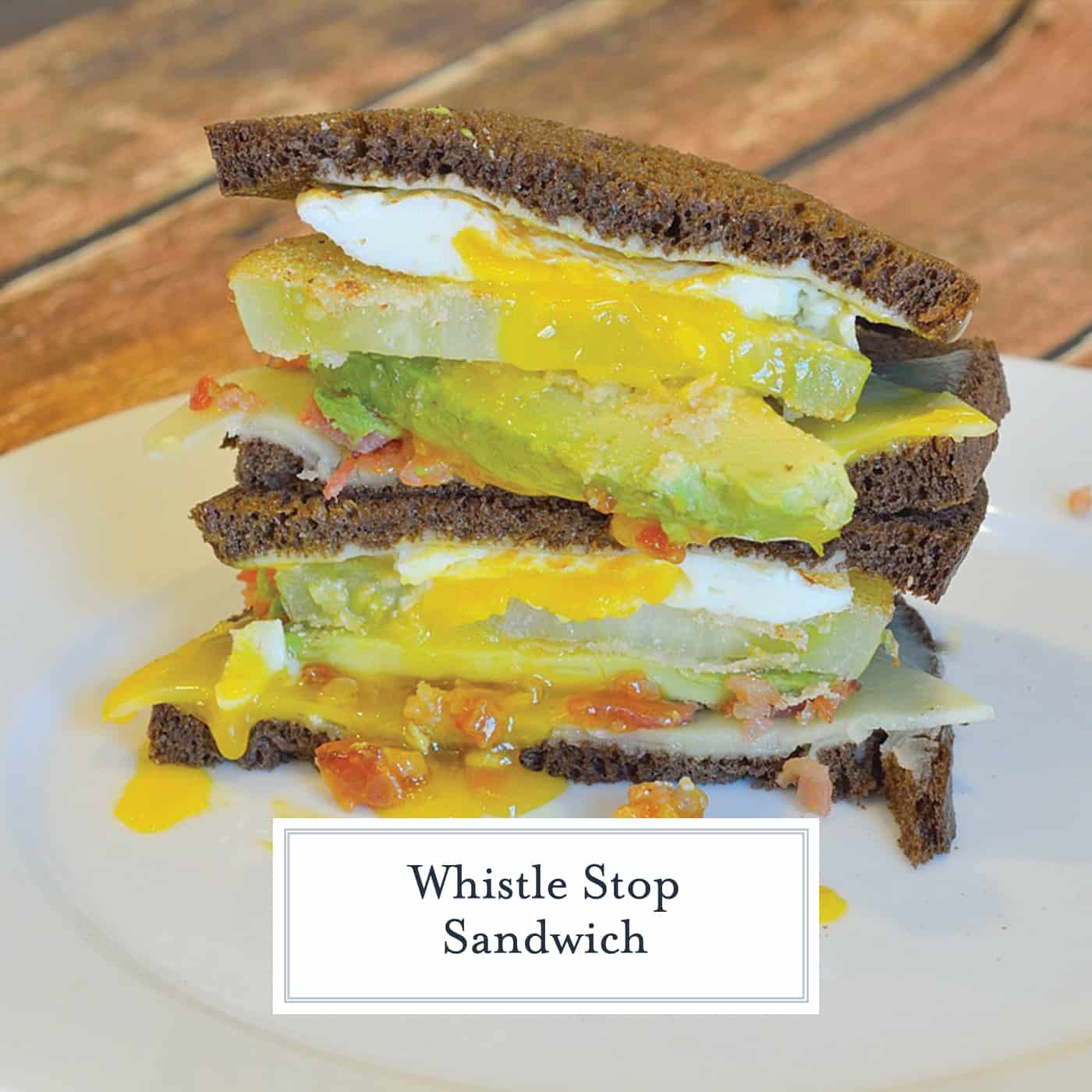 The Whistle Stop Sandwich is a fried drippy egg, avocado, cornmeal crusted green tomato, cheddar and bacon on soft pumpernickel. Crunchy, creamy, sweet and savory. #tomatosandwich www.savoryexperiments.com 